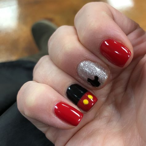 Whimsical Disney-Inspired Nail Design: Vibrant Red, Black, and Glittery Silver with Mickey Mouse Motif.