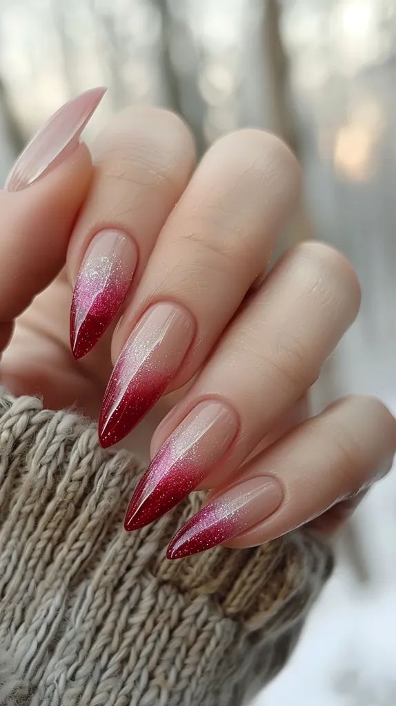 Elegant Ombre Nail Design: Soft Nude to Striking Red with Glitter Accents.