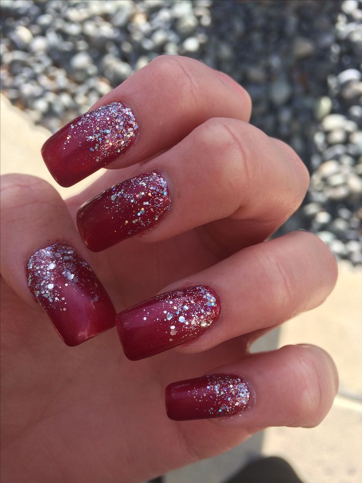 Glamorous Gradient Red Nails with Sparkling Silver Glitter for Special Occasions.