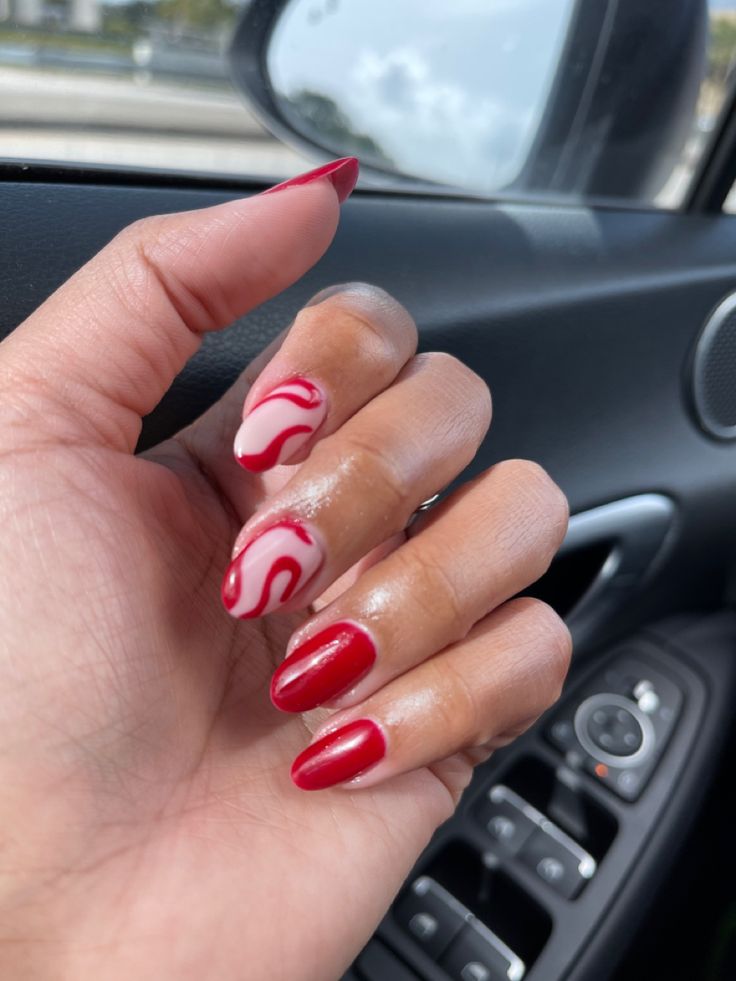 Vibrant Red and White Nail Design with Creative Swirls for Bold Style.