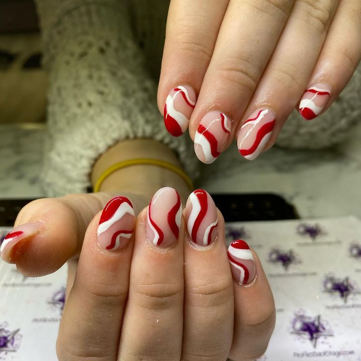 Dynamic Red and White Swirl Nail Design for a Bold Fashion Statement.