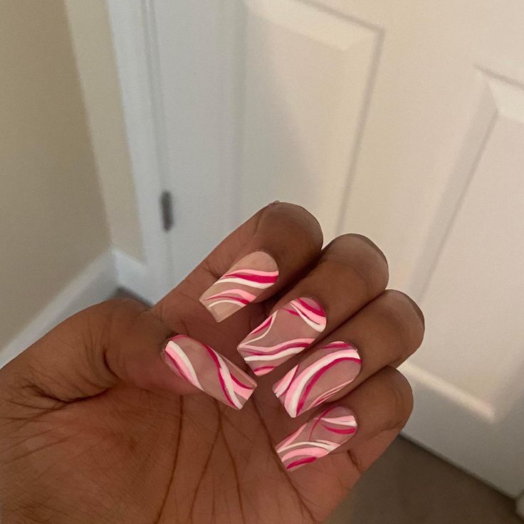 Lively Pink and White Swirl Nail Design: A Playful Elegance for Any Occasion.