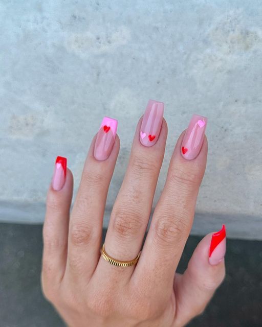 Charming Playful Nail Design with Pink and Nude Shades and Whimsical Heart Motifs