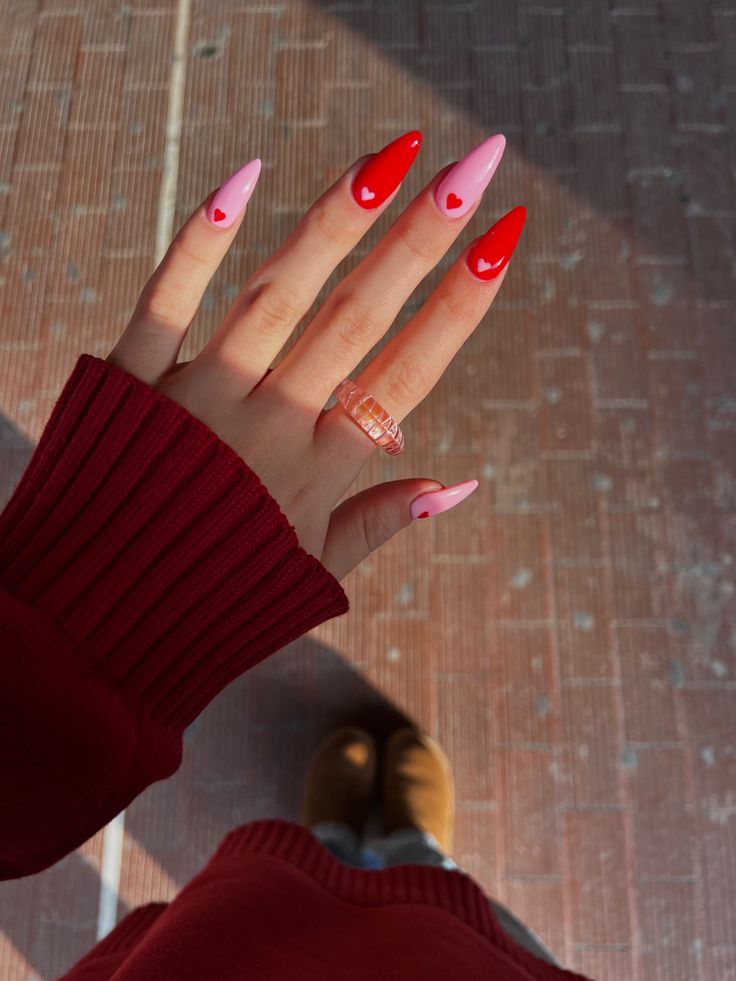 Playful Red and Pink Heart Accented Nail Design for a Fun, Romantic Elegance.