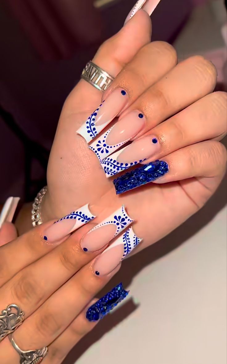 Sophisticated Nail Design: Elegant Nude and Vibrant Blue with Sparkly Accents