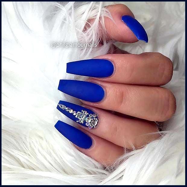 Bold Blue Matte Nails with Striking Gem-Accent Design for Elegant Glamour.