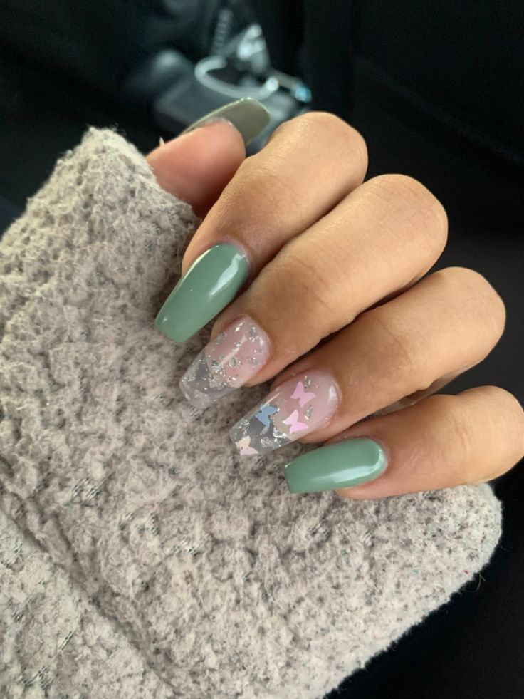 Sophisticated Nail Design: Muted Greens, Glossy Nudes, and Whimsical Glitter Accents.