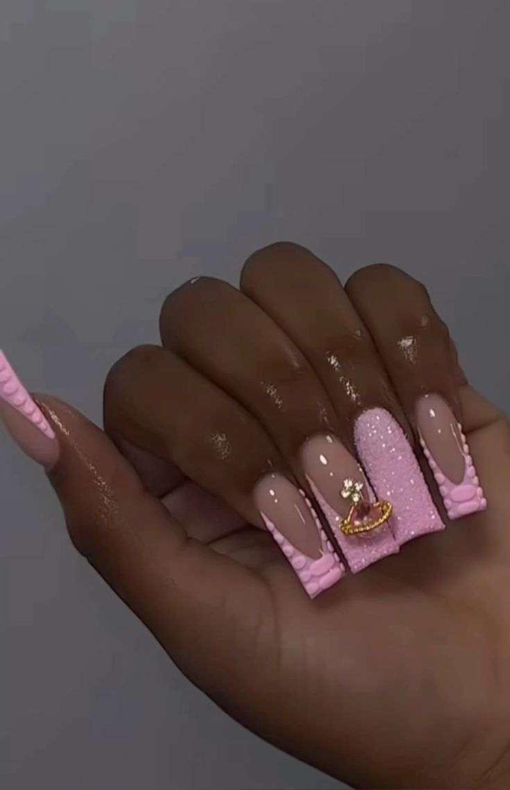 Elegant Soft Pink Nail Design with Textured Accents and Sparkling Embellishments