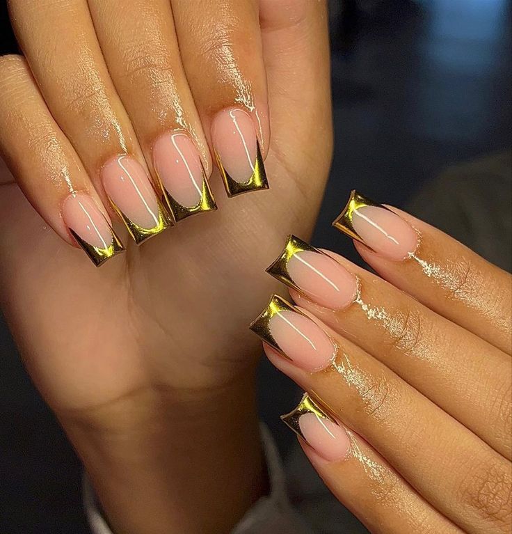 Sophisticated Nude Nail Design with Glam Gold Tips and Delicate White Accents.