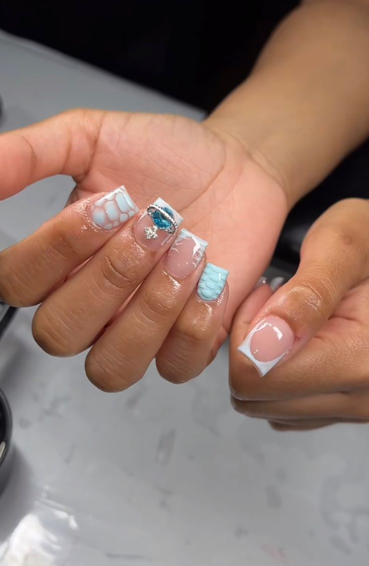 Chic Coastal Nail Design with Soft Pastels, Intricate Patterns, and Sparkling Accents.