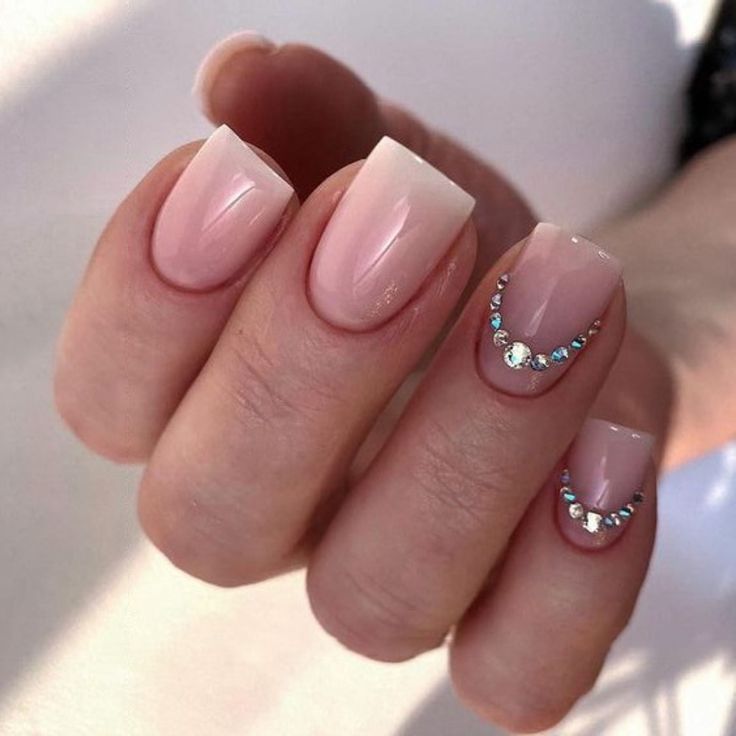 Elegant Ombre Nails: A Glamorous Sheer Pink to Crisp White Gradient with Rhinestone Accents.