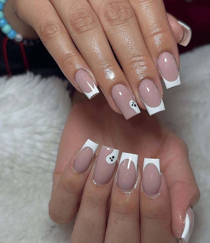 Whimsical Nude and White Nail Design with Playful Ghost Motif.