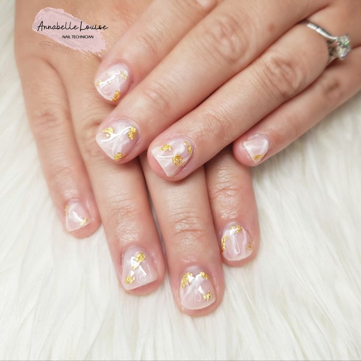 Sophisticated Soft Pink Nail Design with Golden Floral and Geometric Accents