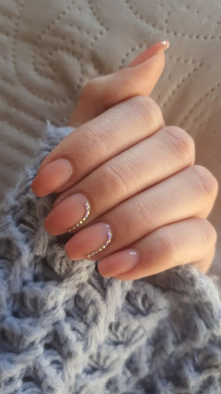 Chic Nude Nail Design with Subtle Shine and Delicate Accents