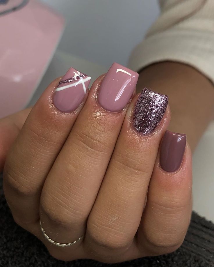 Chic and Sophisticated Nail Design with Soft Mauve Shades and Glamorous Accents.