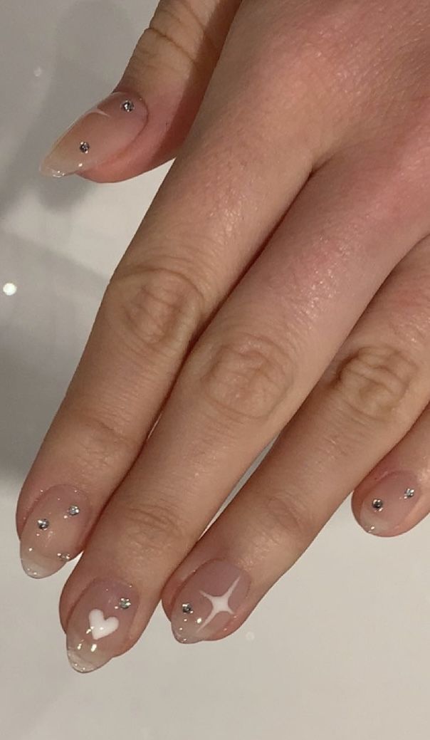 Charming Ombre Nail Design with Rhinestones and Playful Accents.