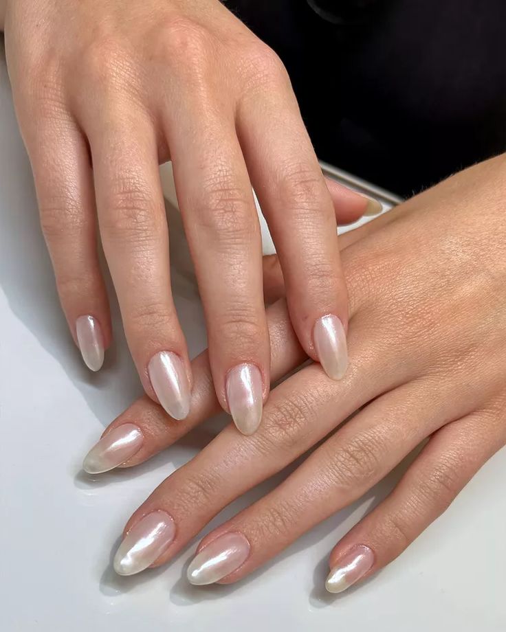 Elegant Ombre Nail Design: Pearlescent Pink to Creamy White for a Sophisticated Touch.