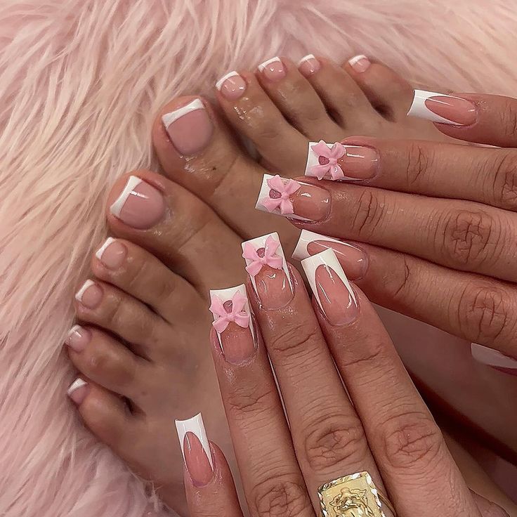 Elegant Pink Floral Nail Design with French Tips and Coordinating Pedicure.