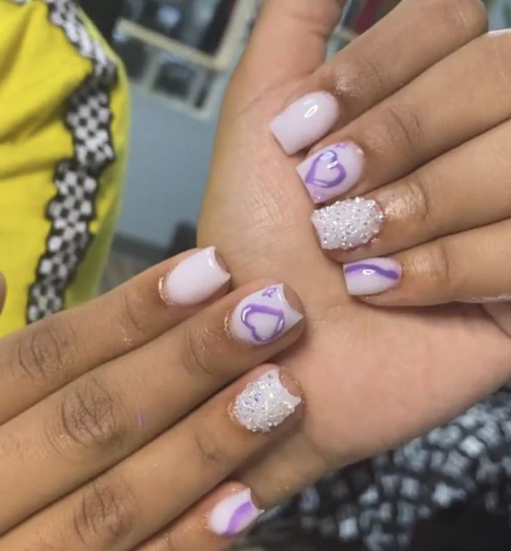 Chic Lavender and White Manicure with Heart Details and Glitter Accents.