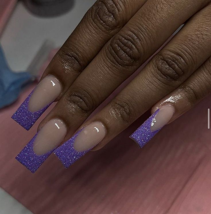 Contemporary Nude and Purple Glitter Tips Nail Design: Elegant Yet Playfully Stylish.