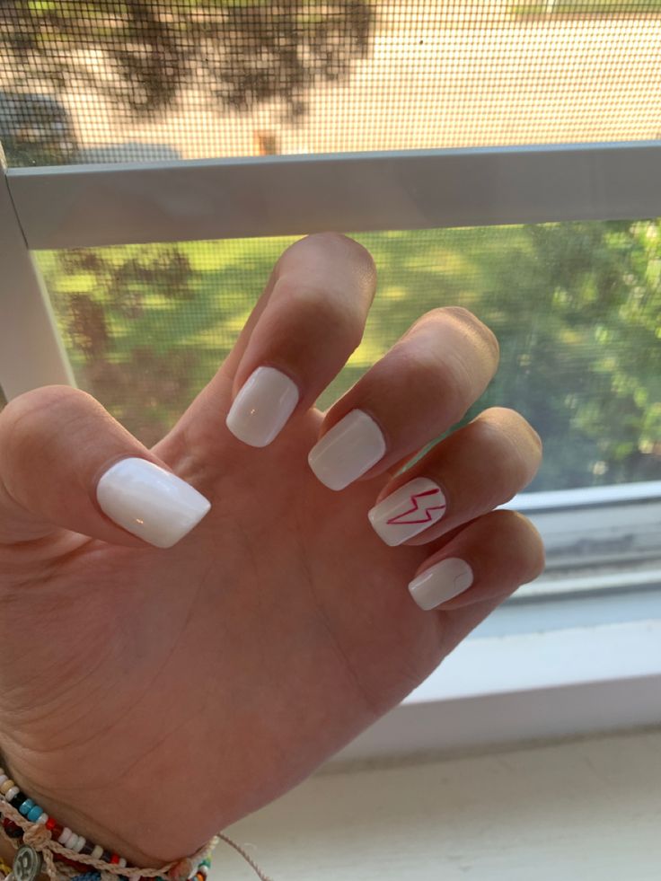 Chic White Manicure with Glossy Finish and Playful Lightning Bolt Design.