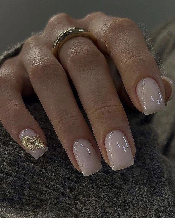 Sophisticated Nude Nail Design with Glossy Finish and Gold Accent.