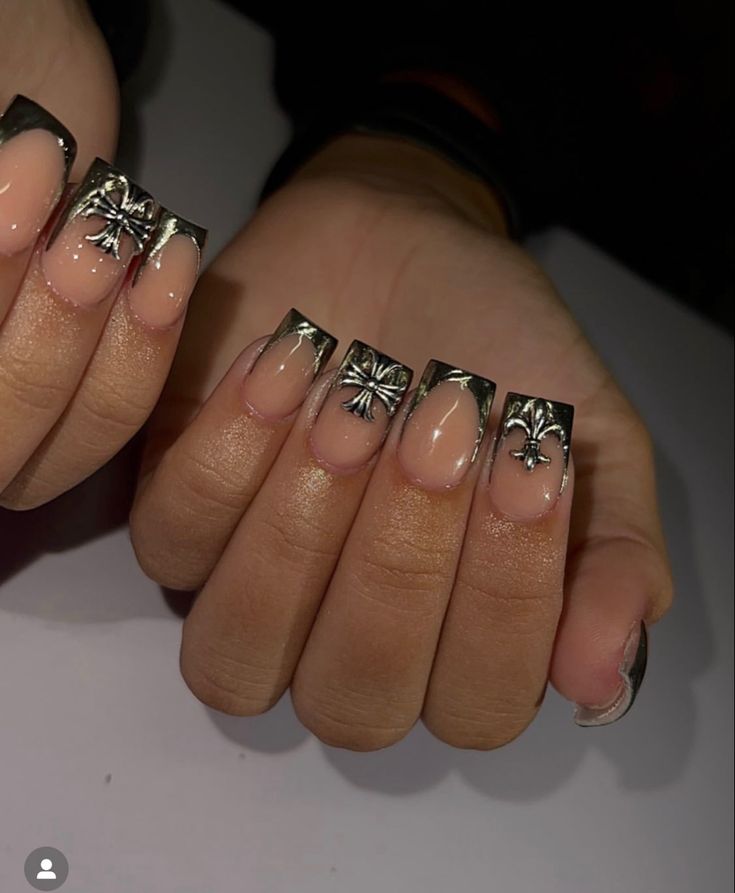 Sophisticated Nude and Metallic Nail Design with Intricate Silver Artwork.