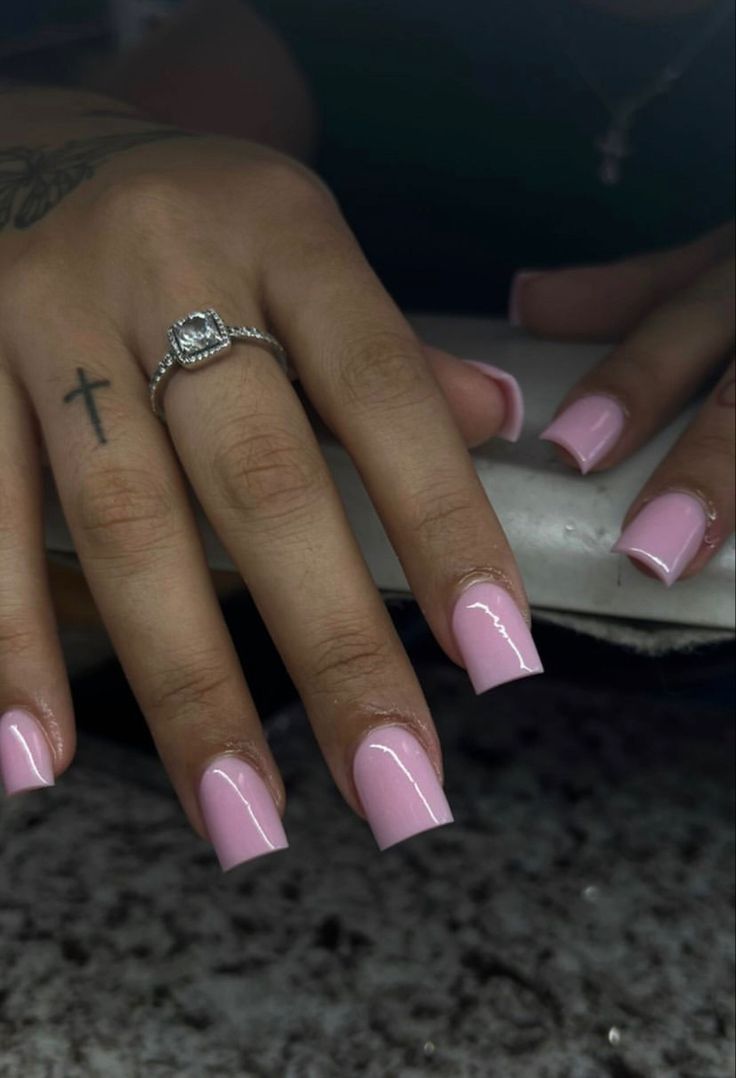 Elegant Pink Square Nails: A Soft, Sophisticated Look with Glossy Finish and Delicate Jewelry.