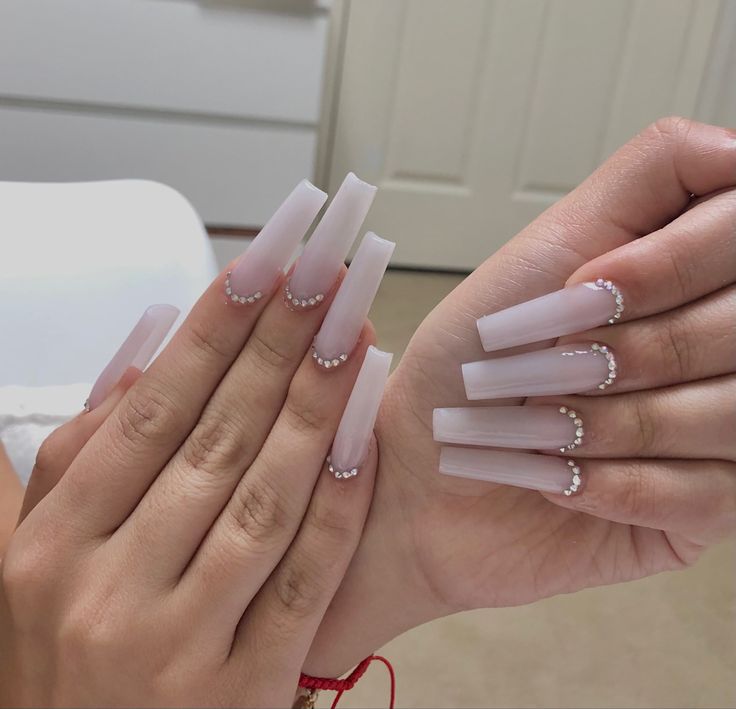 Chic Ombre Nail Design Enhanced with Pearl Accents for a Sophisticated Look.