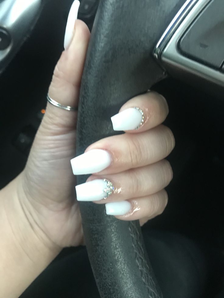 Chic Glossy White Nails with Rhinestone Accents for a Modern Look