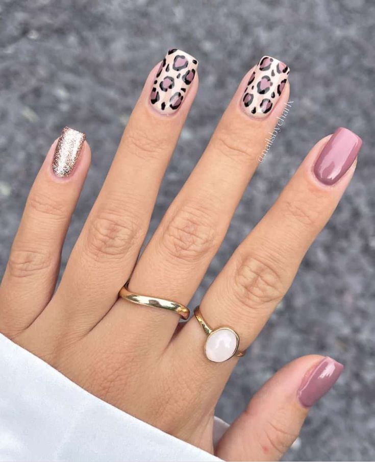 Playful Chic Nail Design: Soft Pink, Leopard Print, and Sparkling Silver Accents.