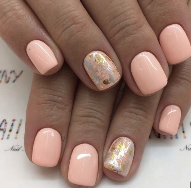 Elegant Soft Peach Manicure with Glossy Finish and Unique Accent Nail Design.