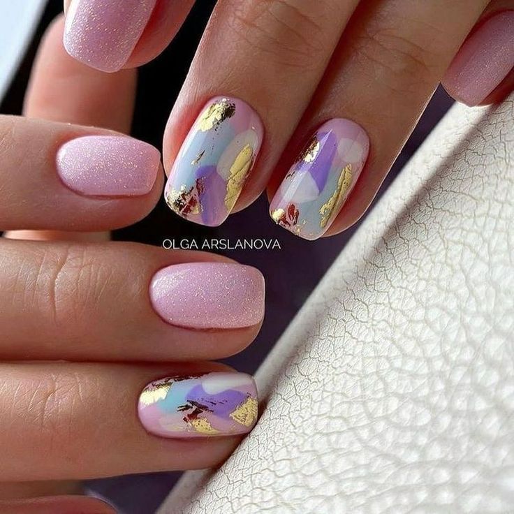 Chic Soft Pink Nail Design with Abstract Art and Glitter Accents.