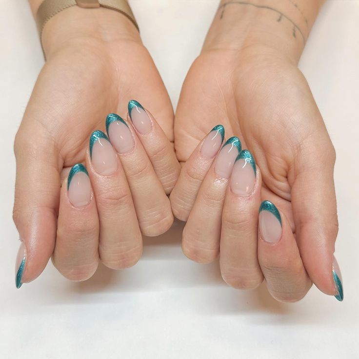 Modern French Manicure with Vibrant Teal Tips and Artistic Accents