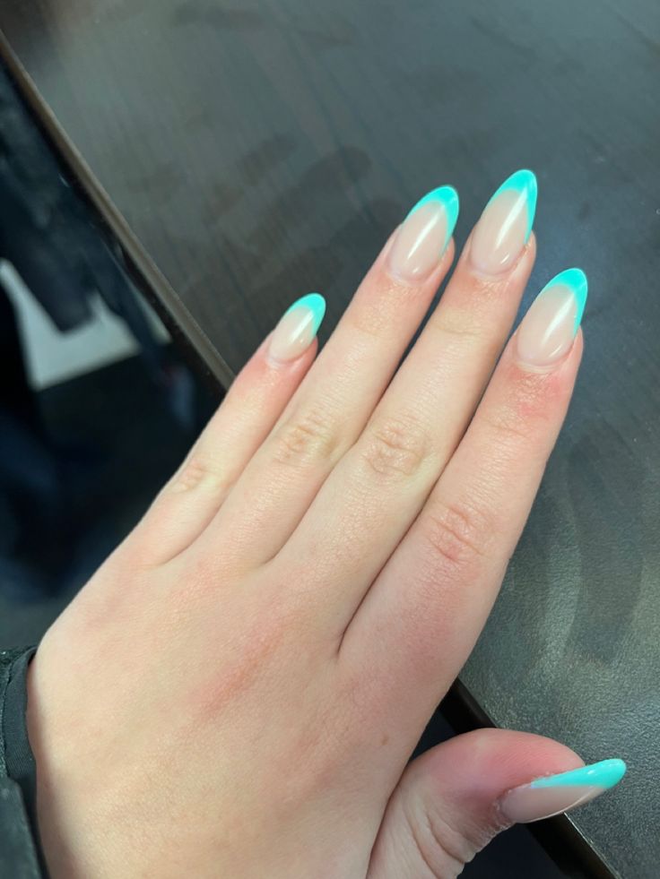 Trendy Almond-Shaped Nail Design: Soft Nude Base with Vibrant Turquoise Tips