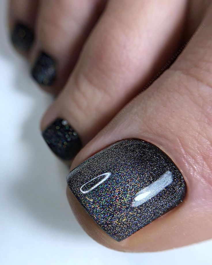 Mesmerizing Holographic Sparkling Black Toenail Art: A Bold Statement for Every Occasion.