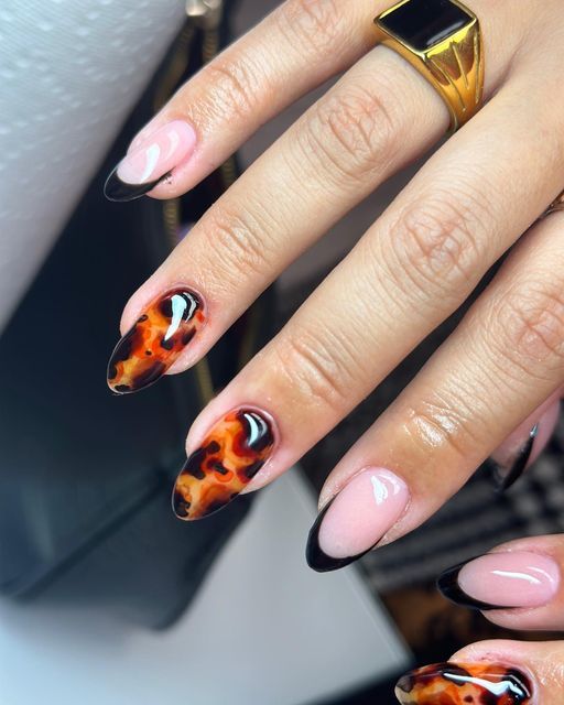 Elegant Nail Design with Glossy Black Tips and Vibrant Tortoiseshell Pattern.