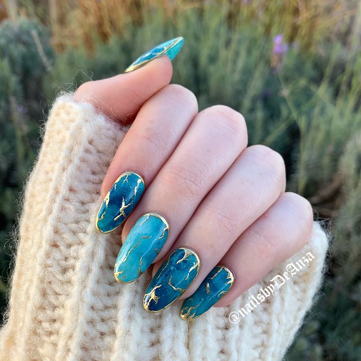 Sophisticated Teal Marble Nail Design with Gold Accents and Unique Color Blend