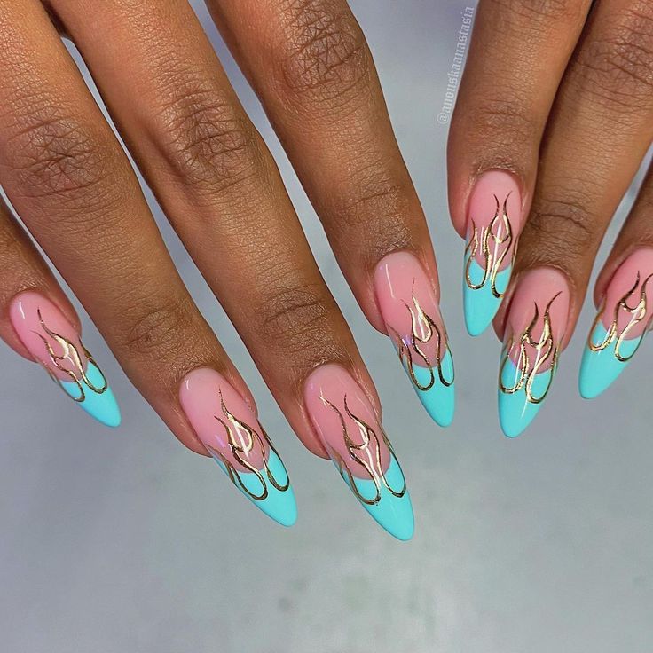 Chic Gradient Nail Design: Soft Pink and Vibrant Teal with Glamorous Gold Flames on Elegant Almond Shape.