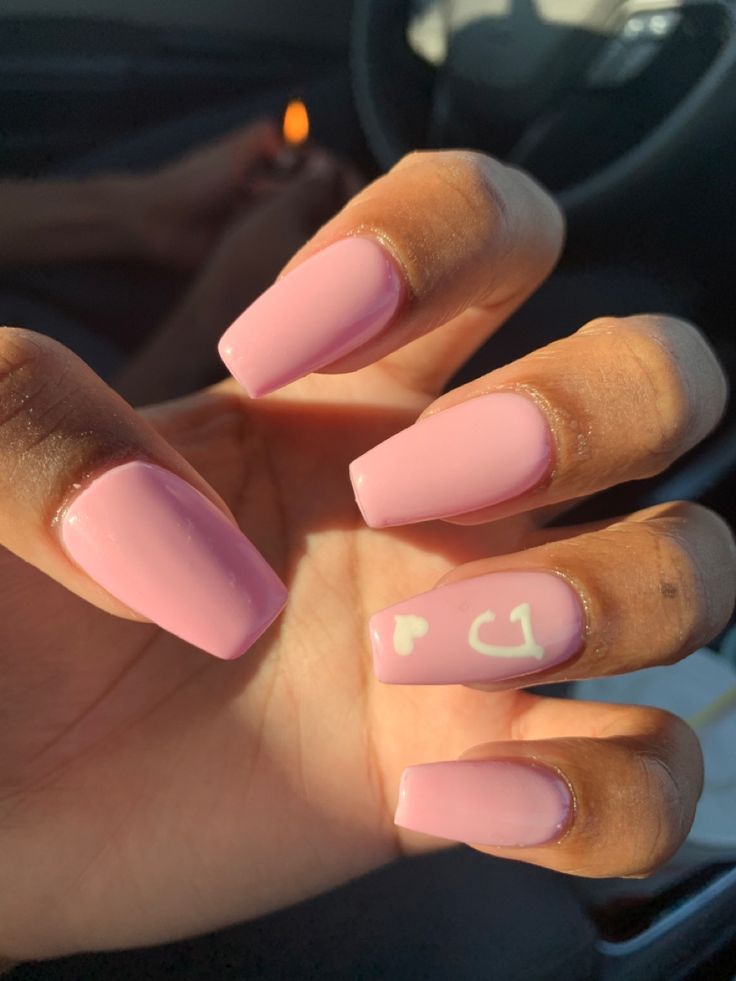 Chic Elegant Pink Glossy Nails with Sophisticated Squared Shape and Playful Art