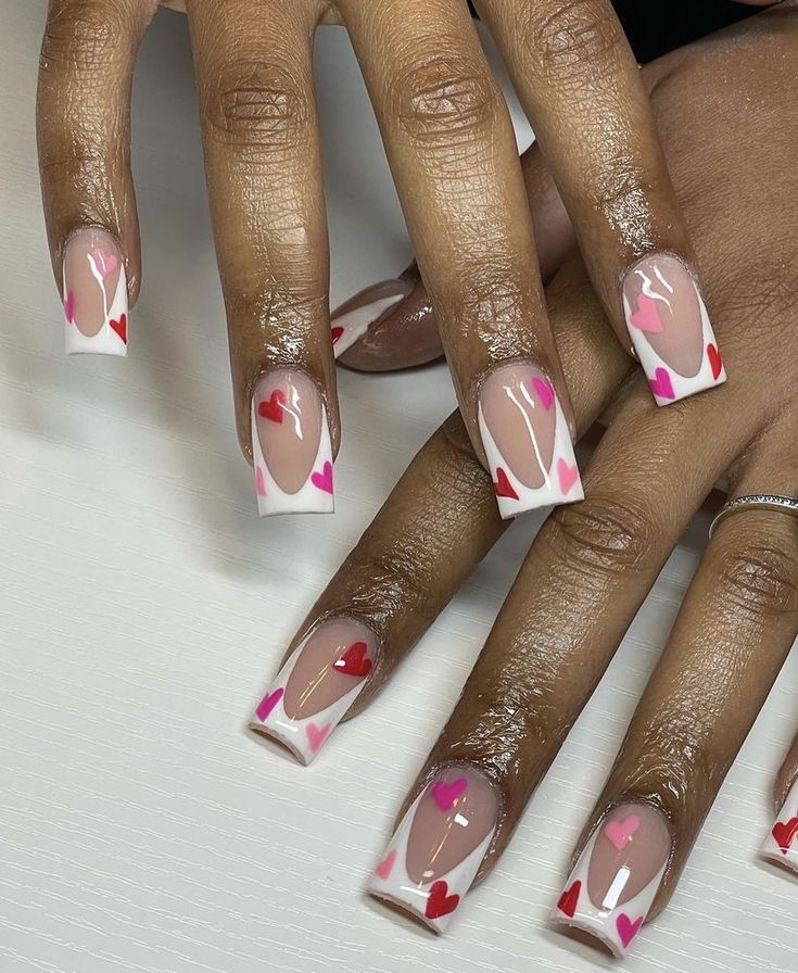 Playful Hearts-Themed Nail Design: Soft Nude and White with Heart Accents.