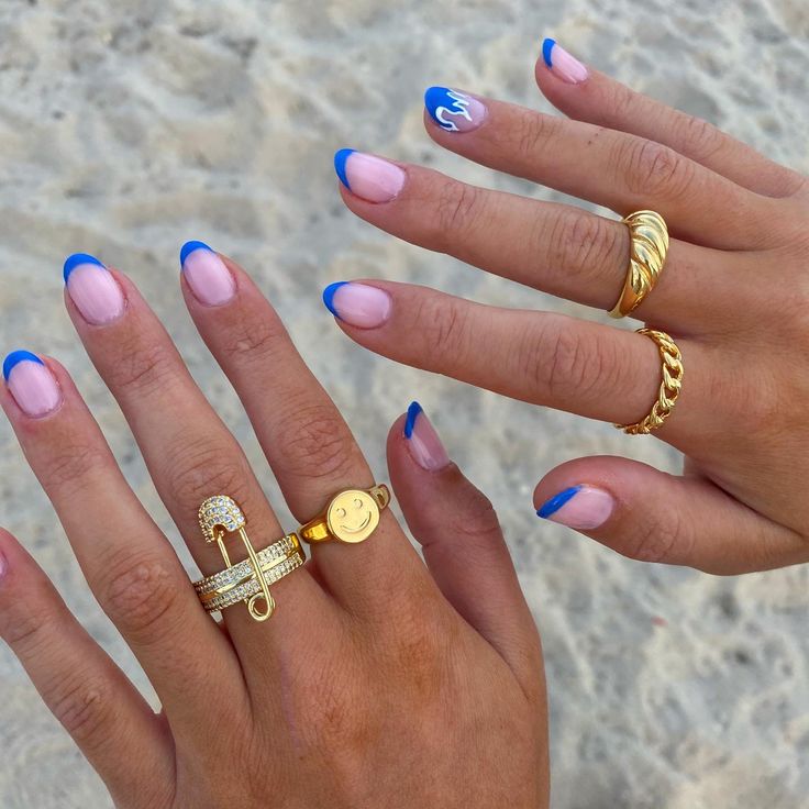 Playful Summer Nail Design: Blue and Nude Palette with Elegant Gold Accents