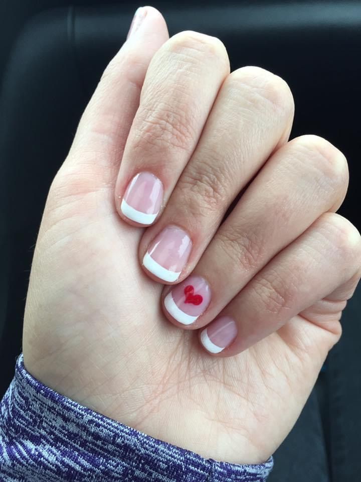 Timeless French Manicure with Playful Heart Accent.