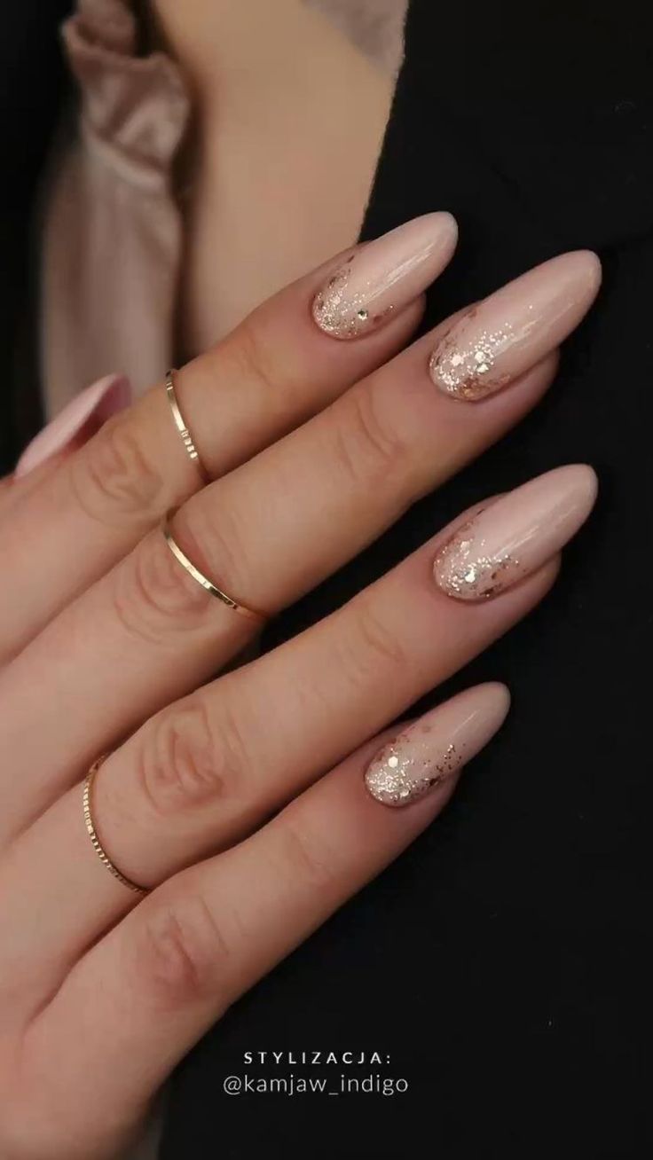 Chic Nude Nail Design with Glitter Gradient and Gold Accents