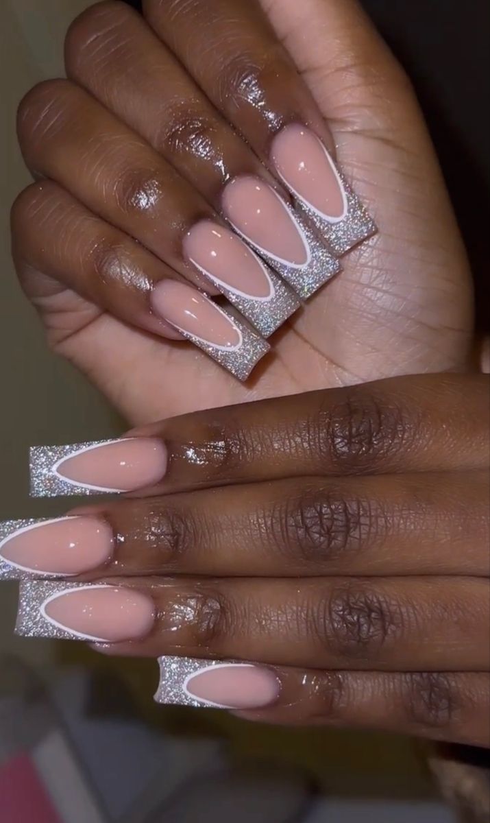 Chic Elongated Nail Design with Nude and Shimmering Silver Accents.