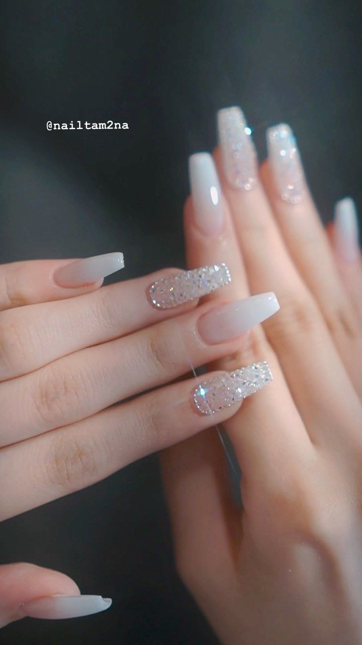 Chic French Tip Nail Design with Glamorous Glitters and Rhinestones.