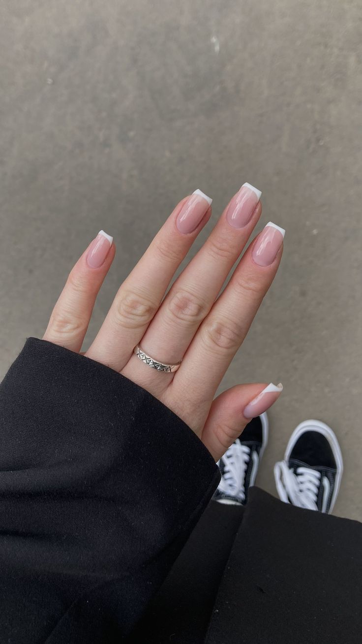 Chic French Manicure: Soft Pink Base with Glossy White Tips for Any Occasion.