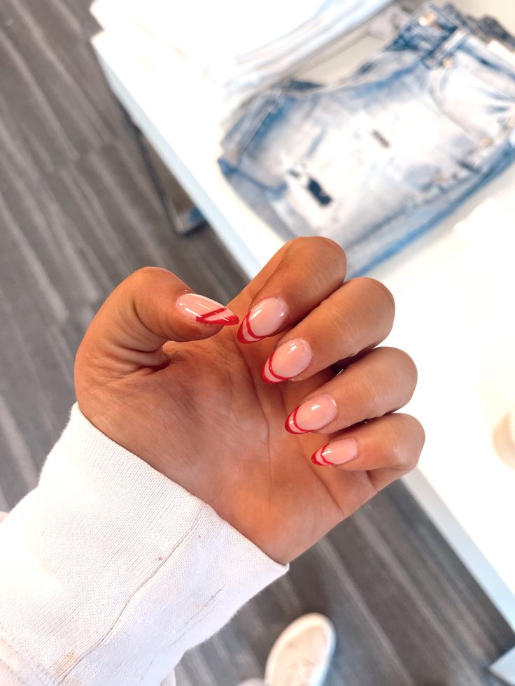 Elegant Nude Base with Bold Red Tips: A Playful Twist on Classic French Manicure.