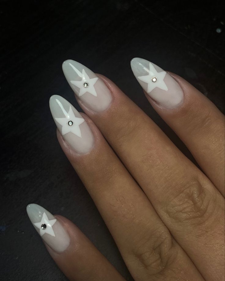 Whimsical Star-Themed Nail Design with Elegant White Base and Gem Accents