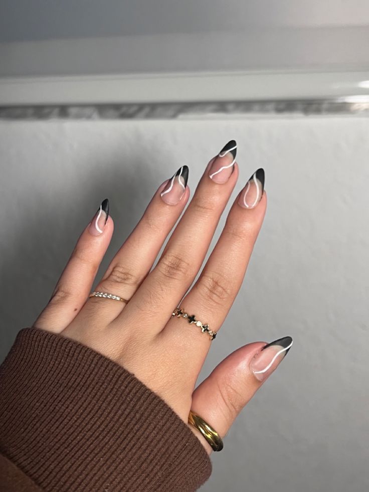 Elegant Modern Nail Design with Clear and Bold Colors Featuring Black Tips and White Accents.